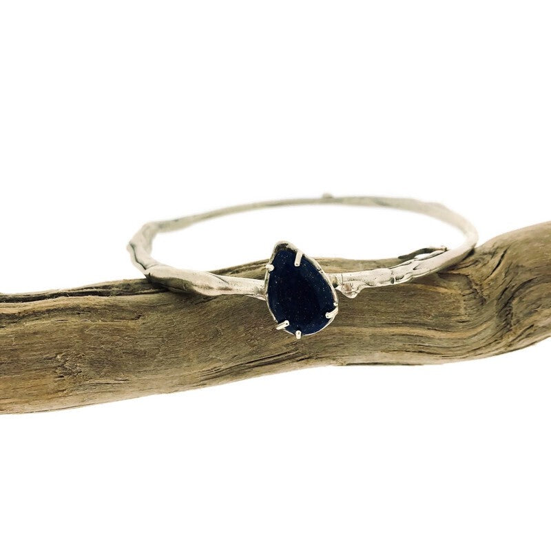 Full view of lapis Shea Bangle with a set teardrop lapis gemstone.