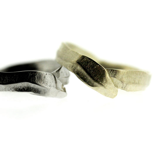 Close up view of white and yellow gold Frond Arch Bands.