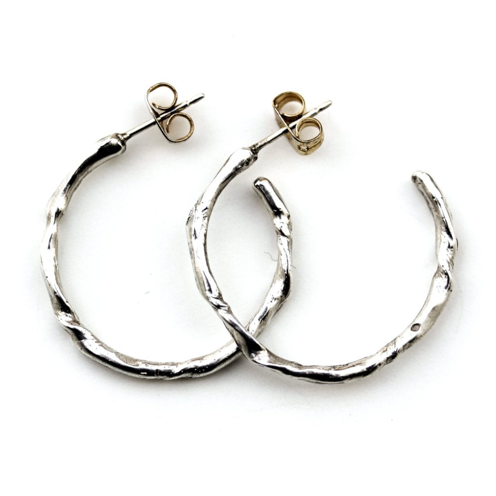 Sterling silver twig hoop earring.