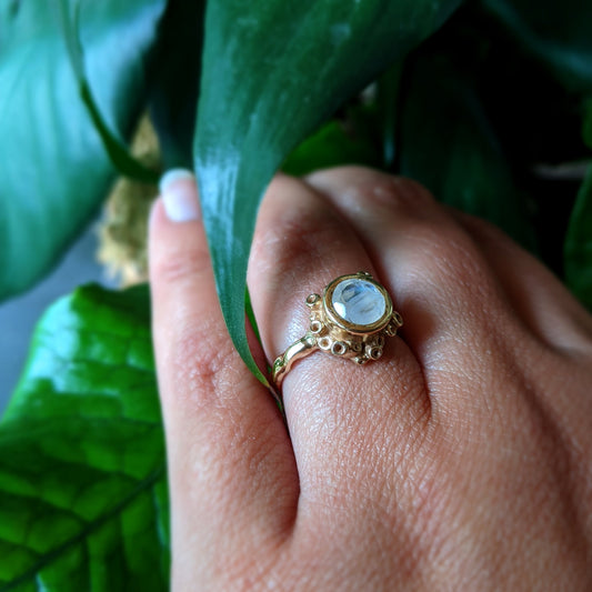 Angled view of Botania Ring on woman's hand to help give an idea of its scale.