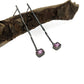 Full view of Pink Sapphire Gina Dangle Earrings laying on top of a stick.