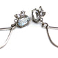 Sterling silver dangle earrings with a cluster of white topaz gemstone in various shapes and a tear drop shaped dangle.