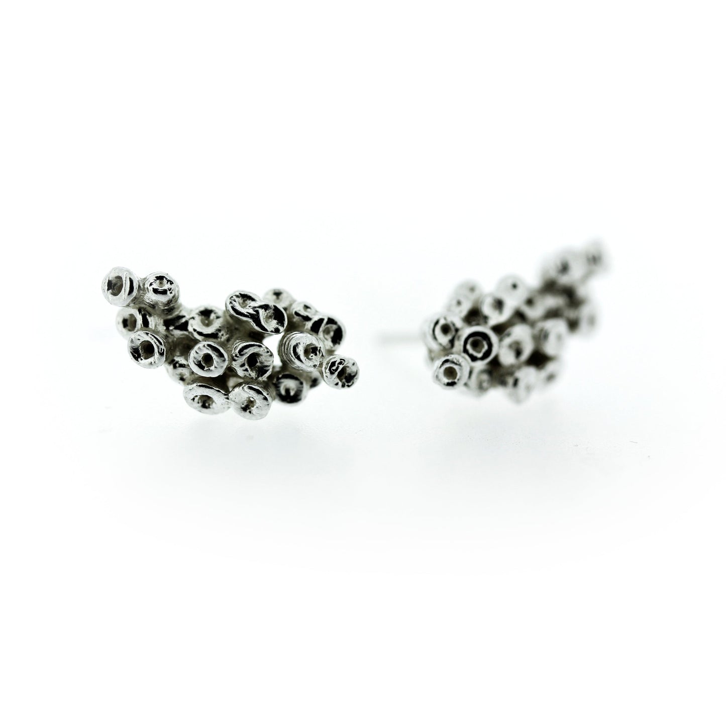 Full view of Ashton Crawler Earrings. These earrings are made of silver, have Katie's signature seasponge texture and are designed with the idea that the earring would crawl up your earlobe.