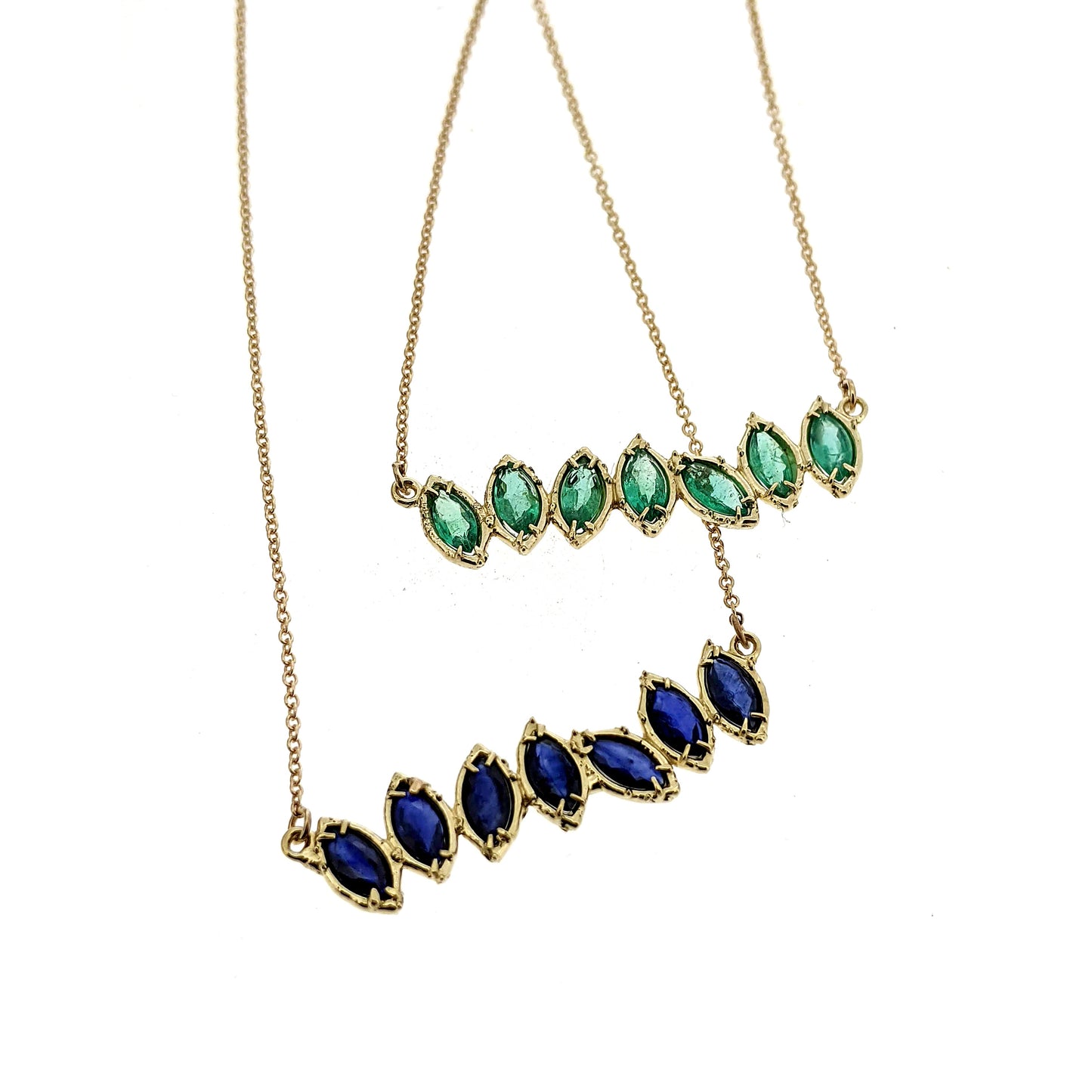 Close up view of green and blue Cherin Necklaces.