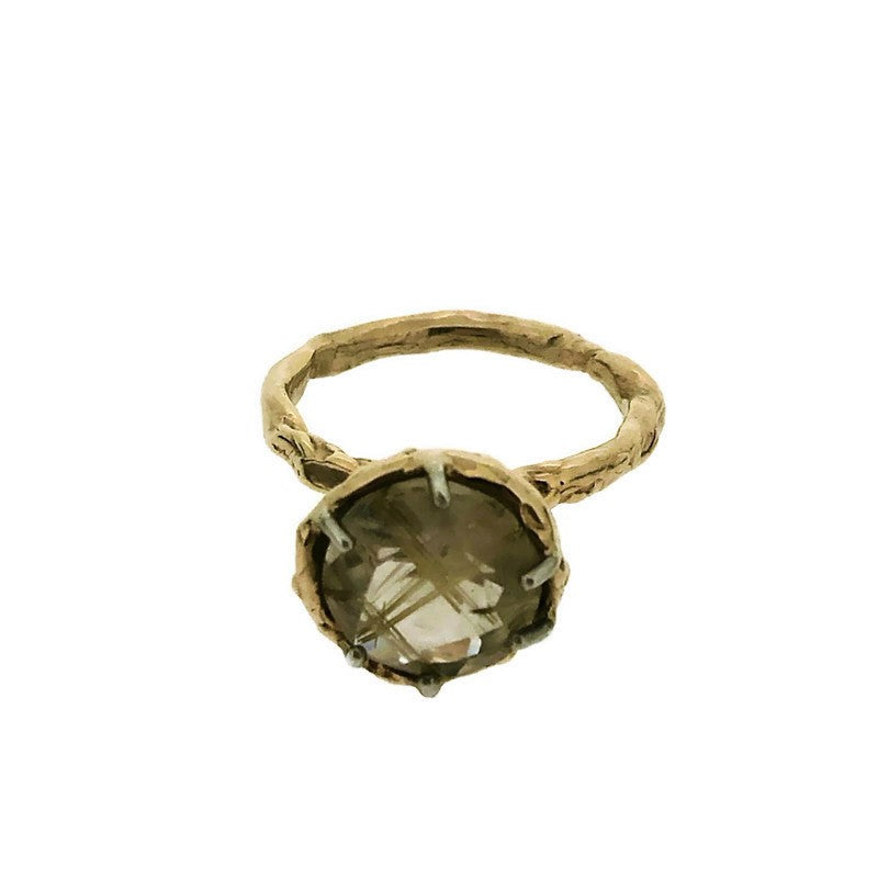 Full view of Rutilated Quartz Ring on white background. This ring showcases a circle shaped rutilated quartz set with six silver prongs and lays on a yellow gold basket setting and yellow gold organically carved band.