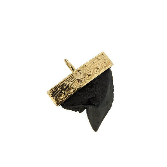 Black and gold custom sharks tooth capped pendant with hand engraved design on a white background