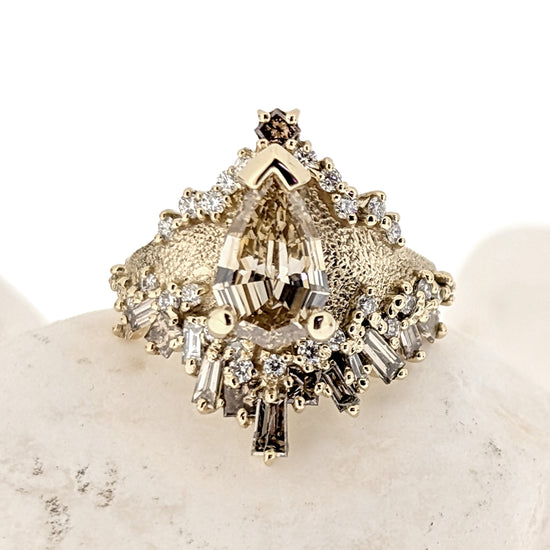 Custom asymmetrical engagement ring with a Champagne center pear shaped diamond and 50 smaller ombre champagne and white natural canadian diamonds