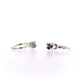 Side views of blue topaz and amethyst Ada Rings sitting next to one another.