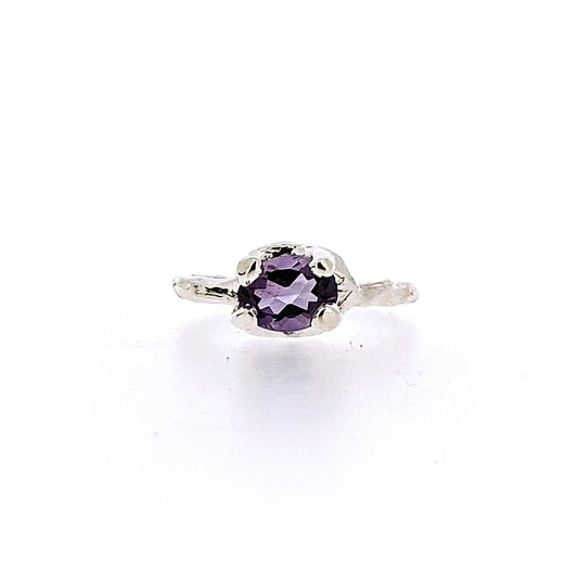 Full view of Ada Ring - Amethyst. This ring features an ovular shaped amethyst set in silver prongs on a silver band.