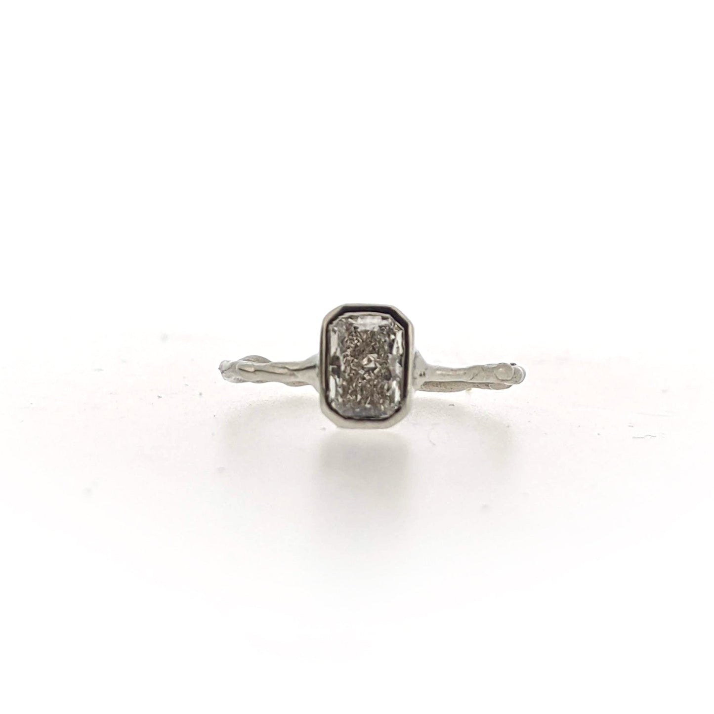 Full view of front of AnnaBeth Diamond Ring. This ring is made of white gold, has an organic texture throughout and a set rectangular shaped diamond at the top.