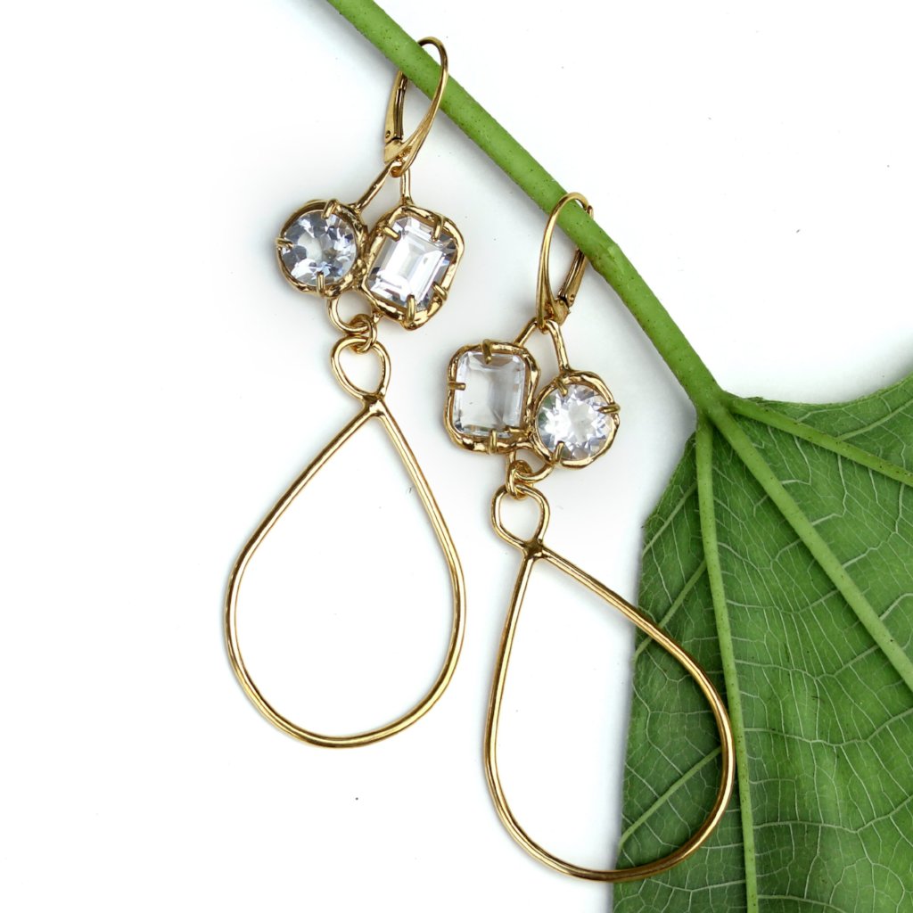 White topaz and gold earrings with long tear drop shaped dangle.