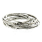 A large stack of sterling silver bangle bracelets that have a smooth organic texture that looks as if they are twigs covered in ice.