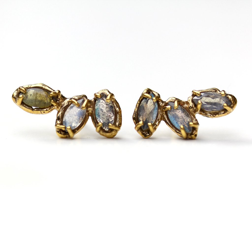 Stud earrings made of three marquise shaped labradorite gemstones set with organic prongs.