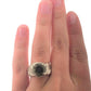 Full view of Citrine Wide Band Ring on woman's fingers to help give an idea of the scale of the piece.