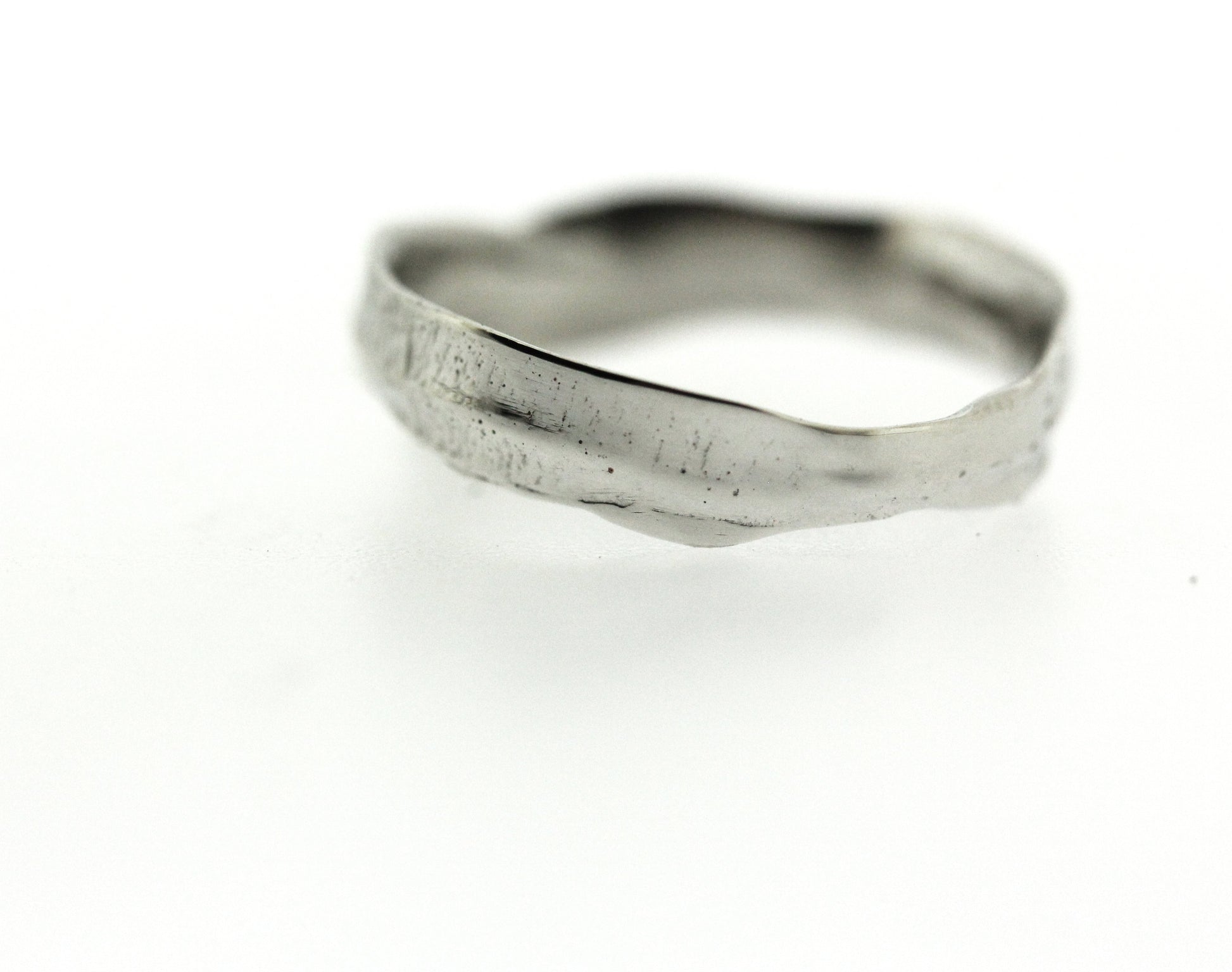Close up view of white gold Frond Arch Band.