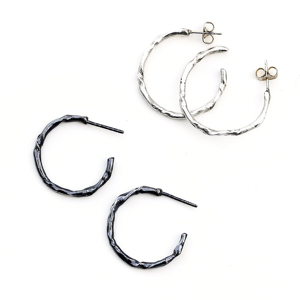 Two pairs of small hoop earrings with an organic twig-like texture.