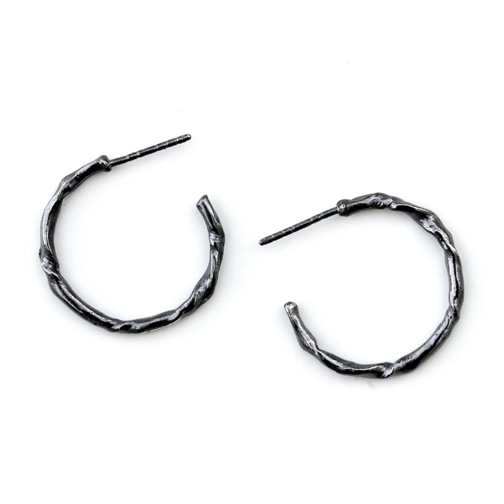 Small hoop earring featuring organic texture resembling a twig or vine.