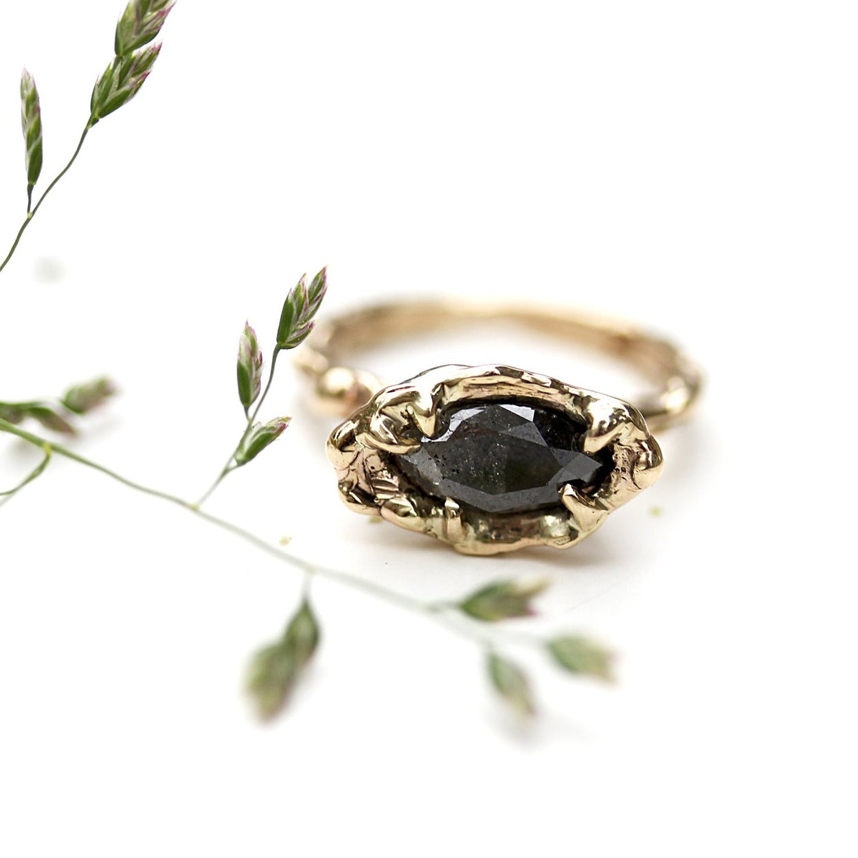 Full view of Marissa Ring. She features an approx 1.3 CT Ombre Gray Marquise Rustic Diamond that transitions from pale gray to smoky black.  She's set sideways to accentuate her color shift and add to her raw personality. She is set on an organic gold band and setting.