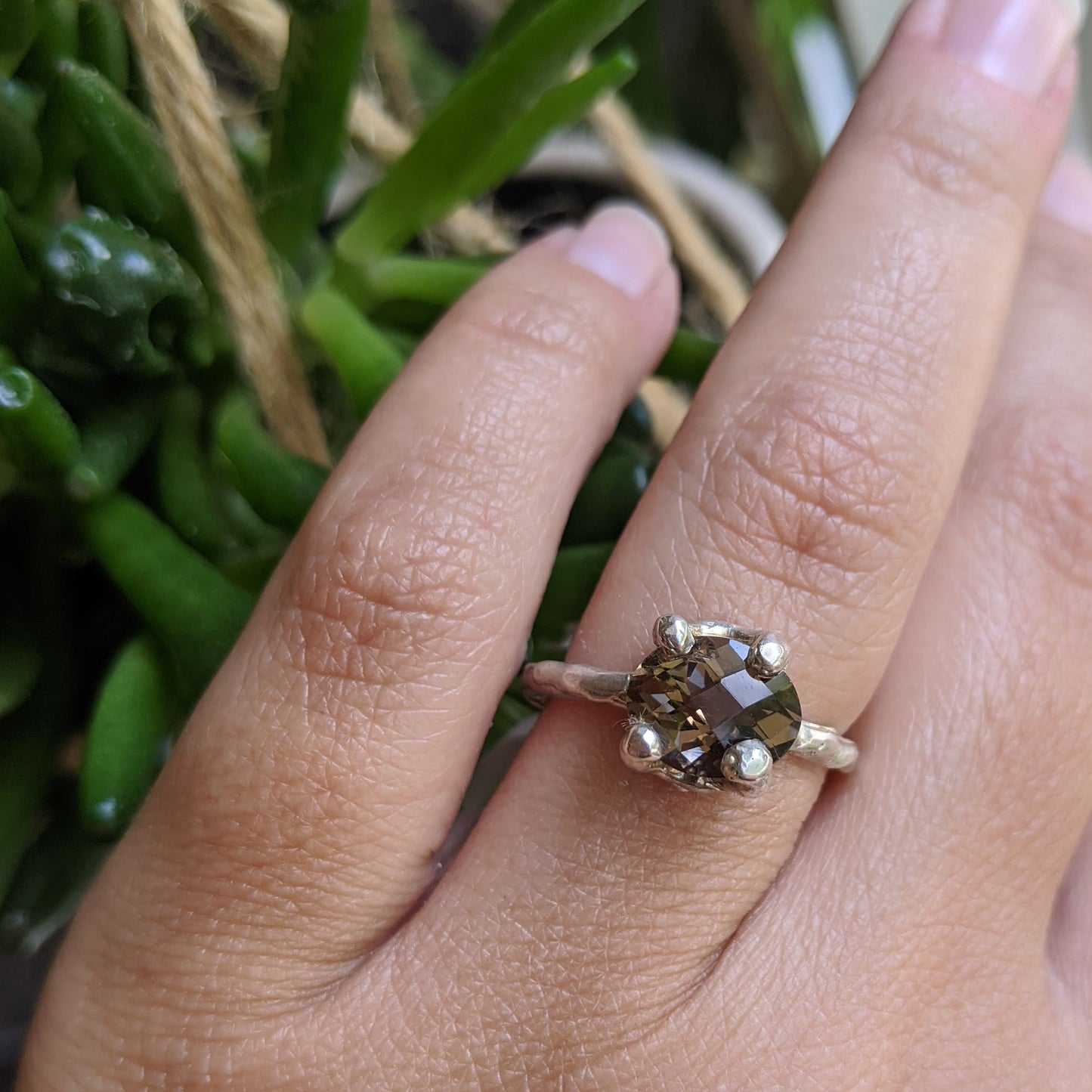 Close up view of Ada Ring on woman's hand to help give an idea of its scale.