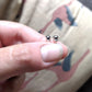 Full view of Black Diamond Stud Earrings being help to help give an idea of their scale.
