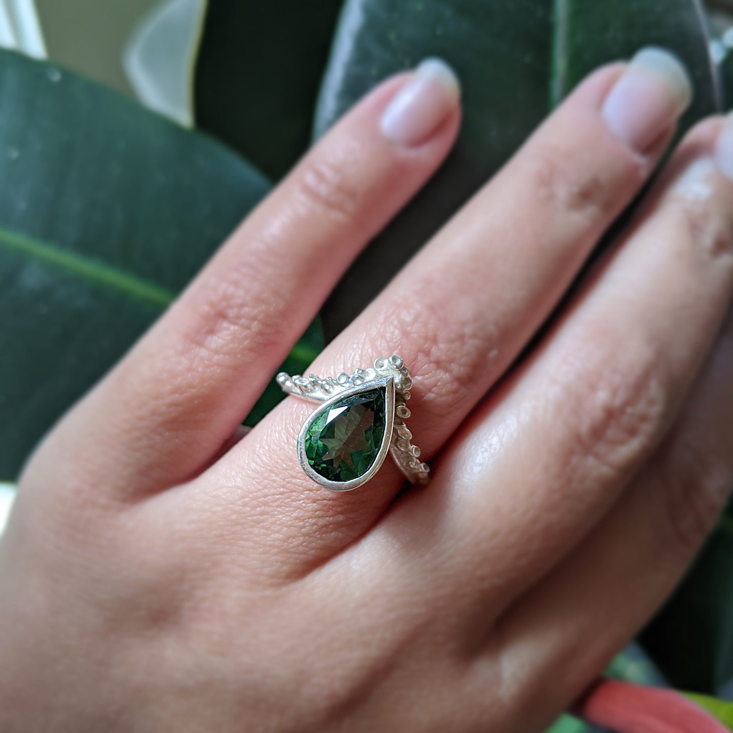 Full view of Gina Ring on woman's finger to help give an idea of its scale. A bright, bold Quartz is nestled amongst delicate texture references the spontaneous surfaces found in nature -- reminiscent of sea sponges or coral.  