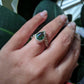 Angled view of Gina Ring on woman's finger.