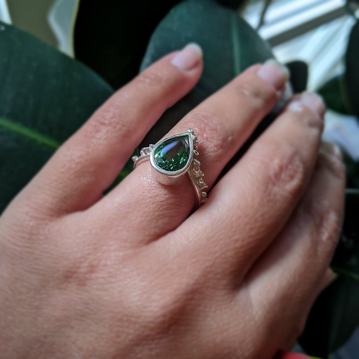 Angled view of Gina Ring on woman's finger.