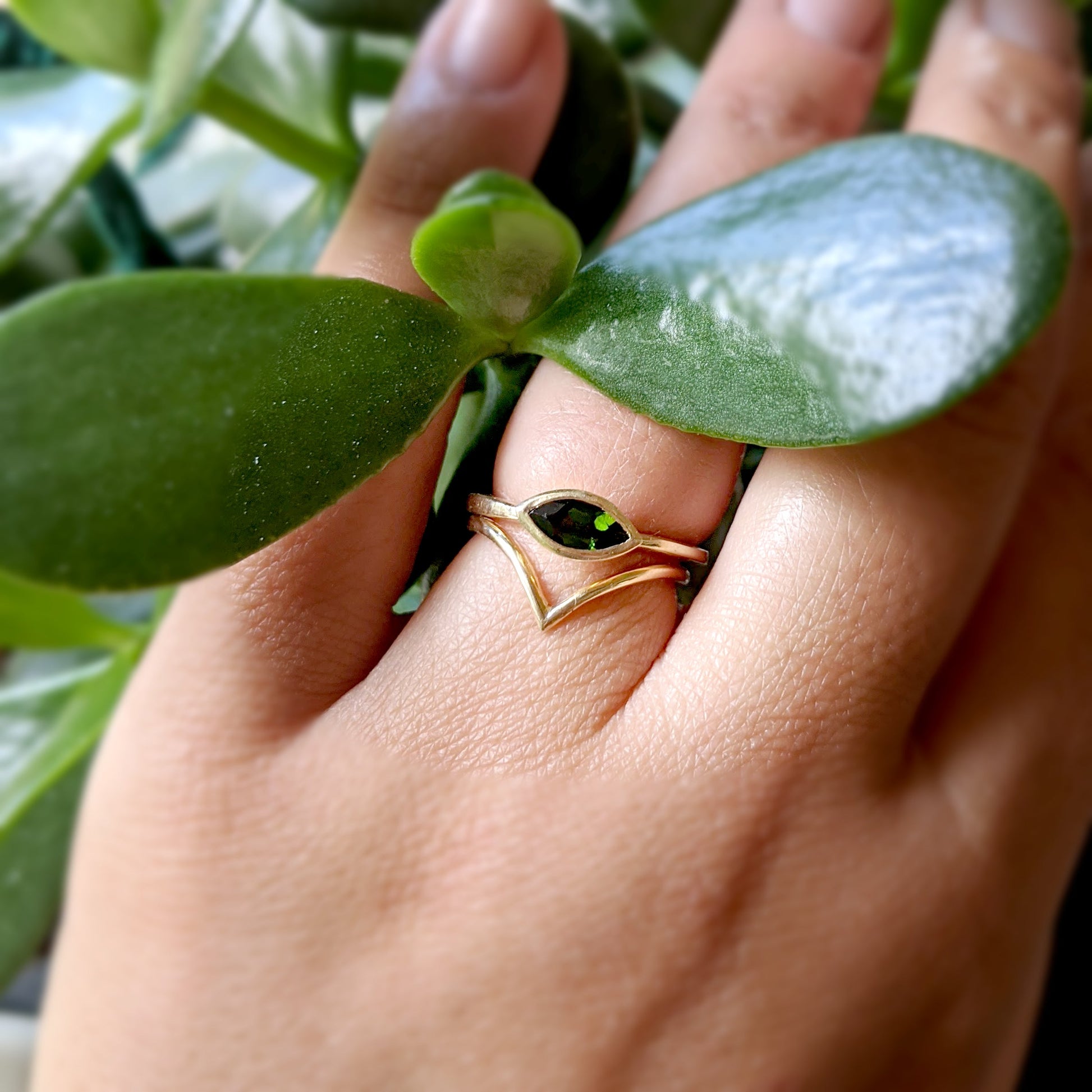 Full view of Olive Ring and V band on woman's hand to help give an idea of their scale.