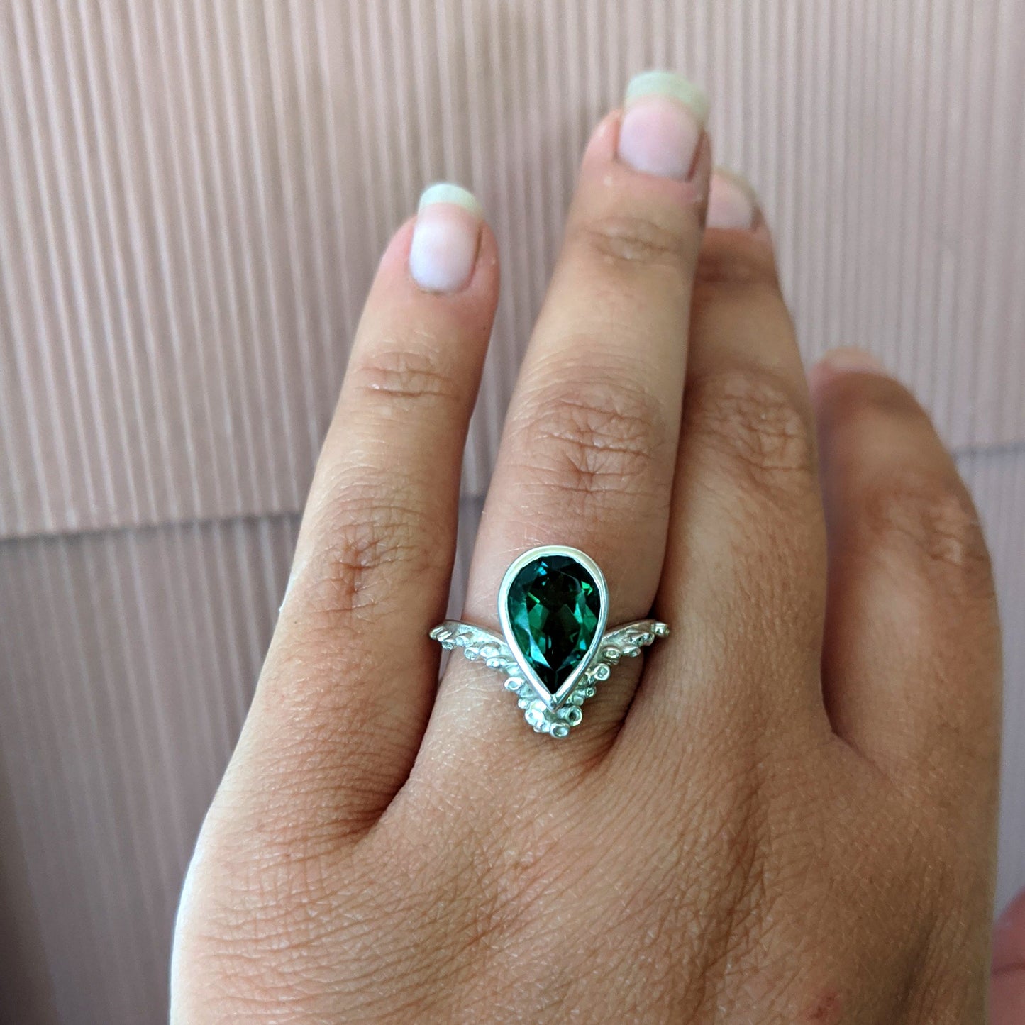 Full view of Gina Ring on woman's hand to help give an idea of its scale. A bright, bold Quartz is nestled amongst delicate texture references the spontaneous surfaces found in nature -- reminiscent of sea sponges or coral.  