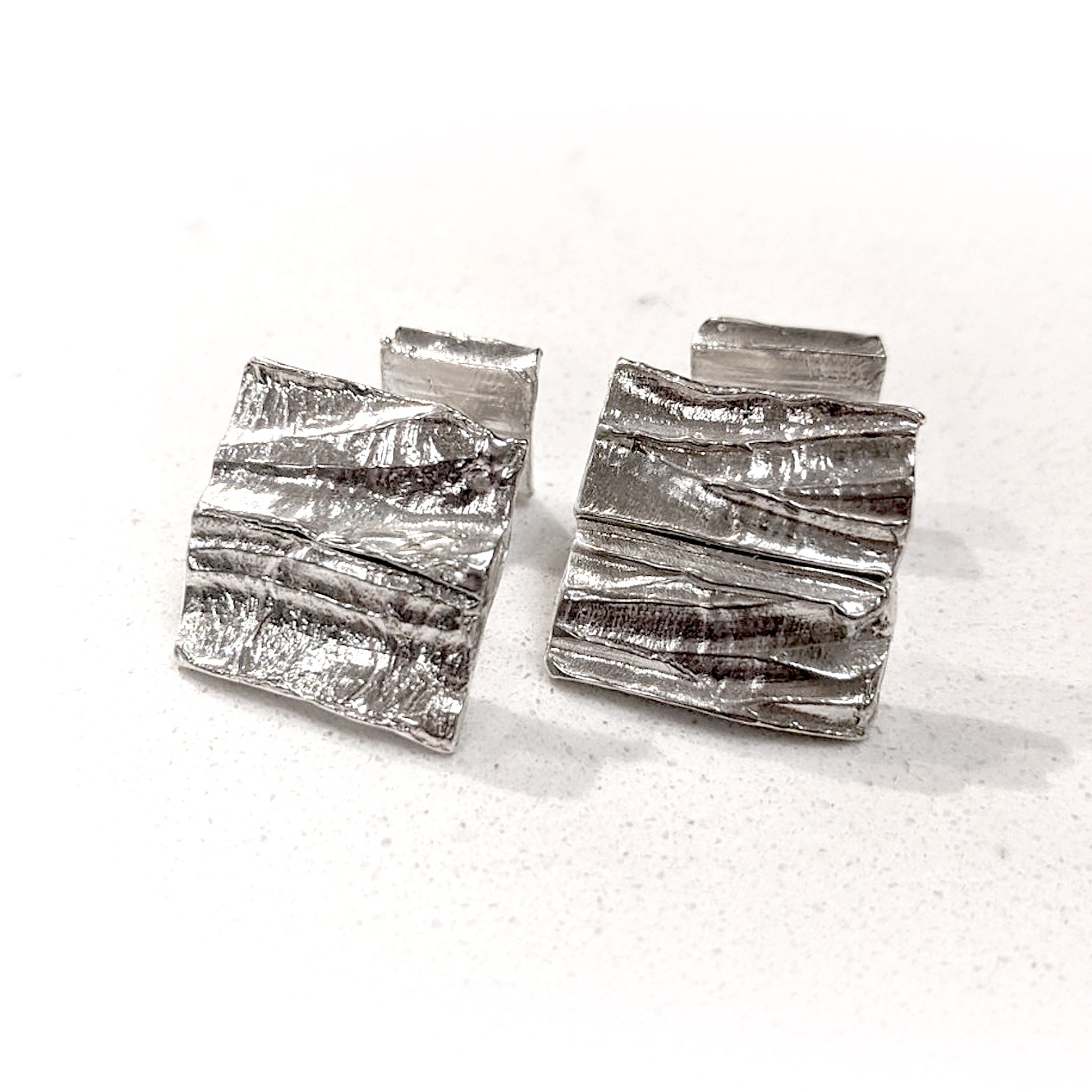 Full view of Summit Cufflinks. The Summit Cufflinks are hand carved from wax and cast in solid Sterling Silver.   Featuring a contemporary, organic ridgeline design that is reminiscent of peaks, valleys, or geographic features.