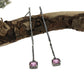 Full view of Pink Sapphire Gina Dangle Earrings laying on top of a stick.
