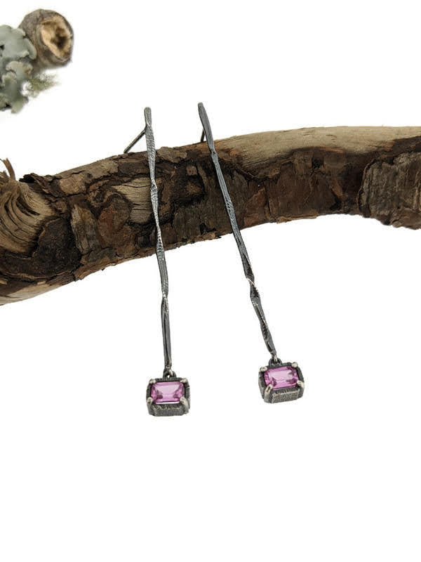 Full view of Pink Sapphire Gina Dangle Earrings laying on top of a stick.