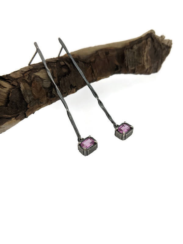 Full view of Pink Sapphire Gina Dangle Earrings laying on top of a stick.