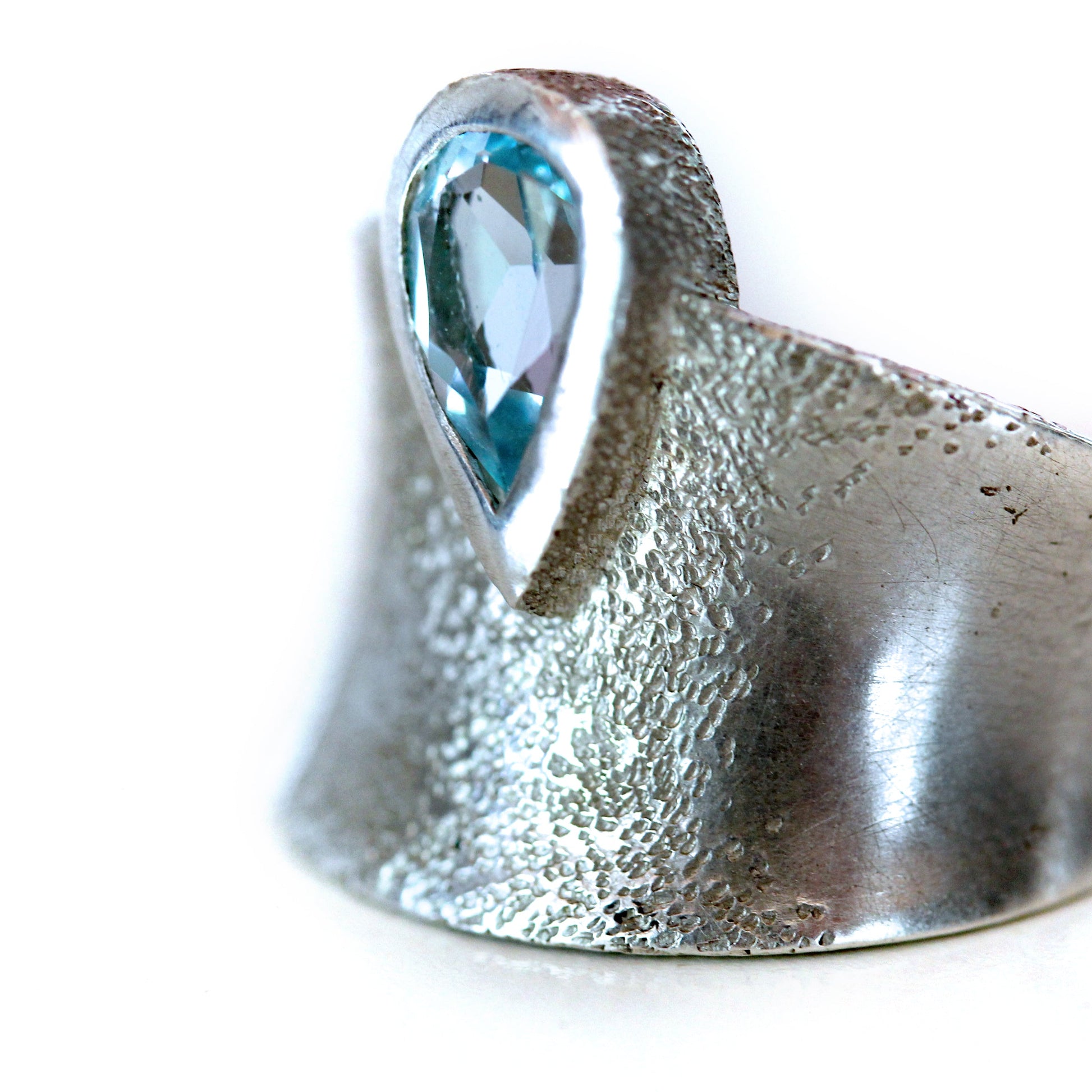 Close up view of the side of Astoria Ring. This ring has a dappled texture throughout its band.
