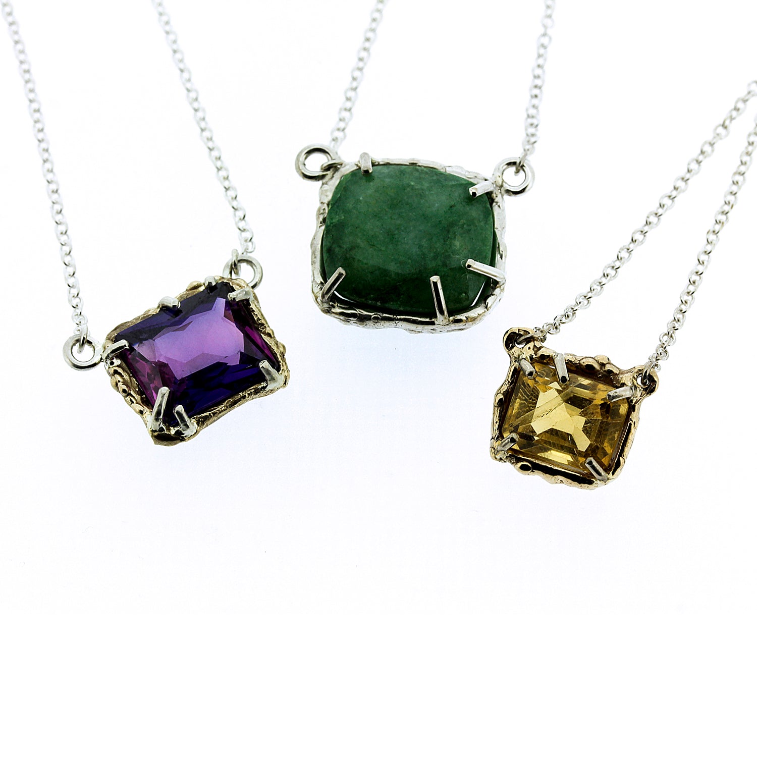 Close up view of the pendants on three different Dinah Necklaces.