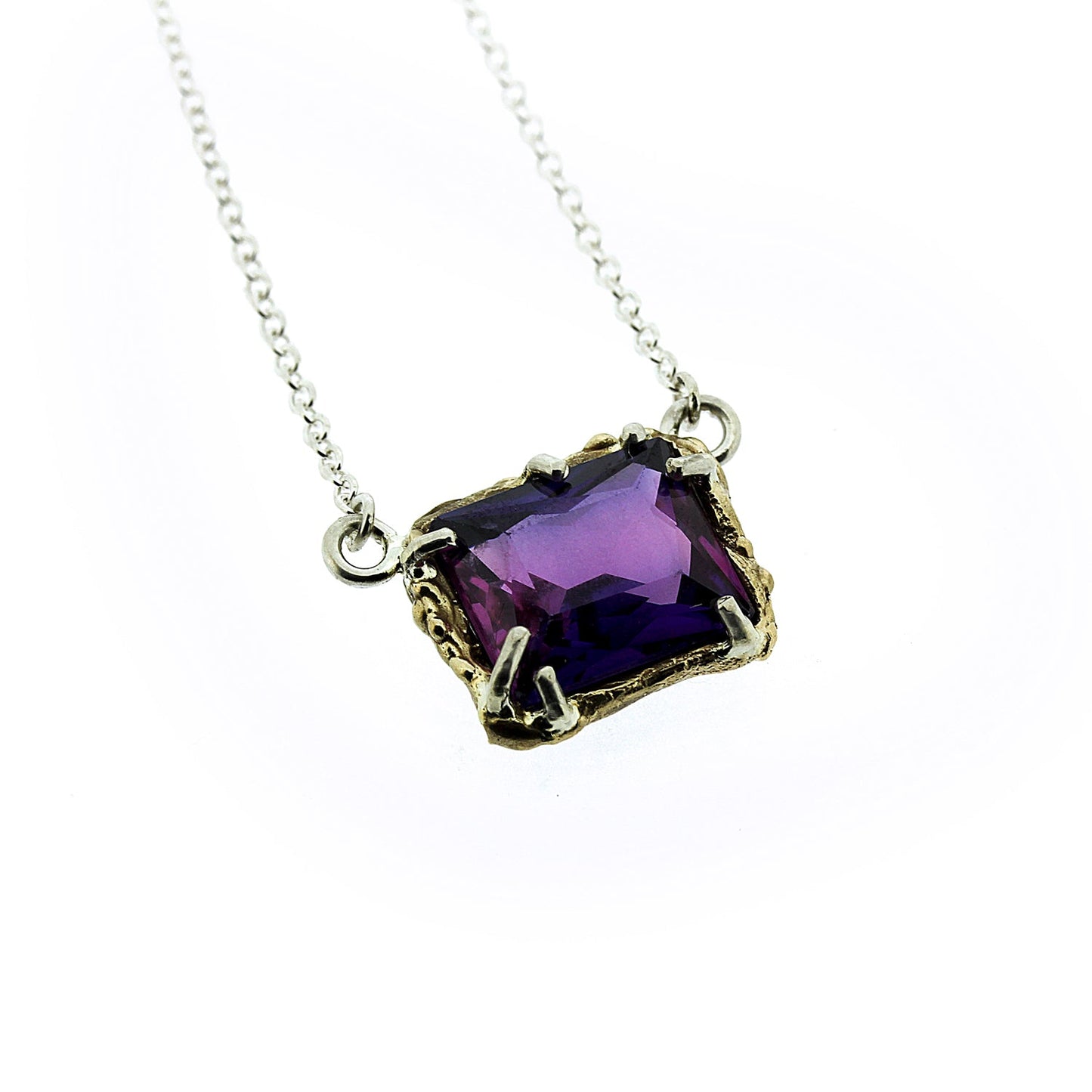 Close up view of pendant on Dinah Necklace - Purple Sapphire. This necklace is made of yellow gold and has a set rectangular purple sapphire.