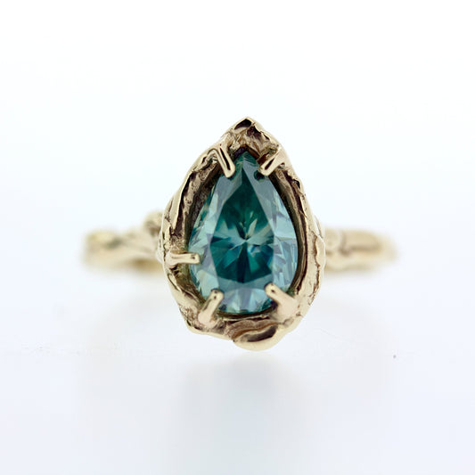 Full view of Nessa Ring. One of a kind Organic design ring featuring a large 1.57 Carat Blue Green Moissanite set in organic 14K yellow gold.    