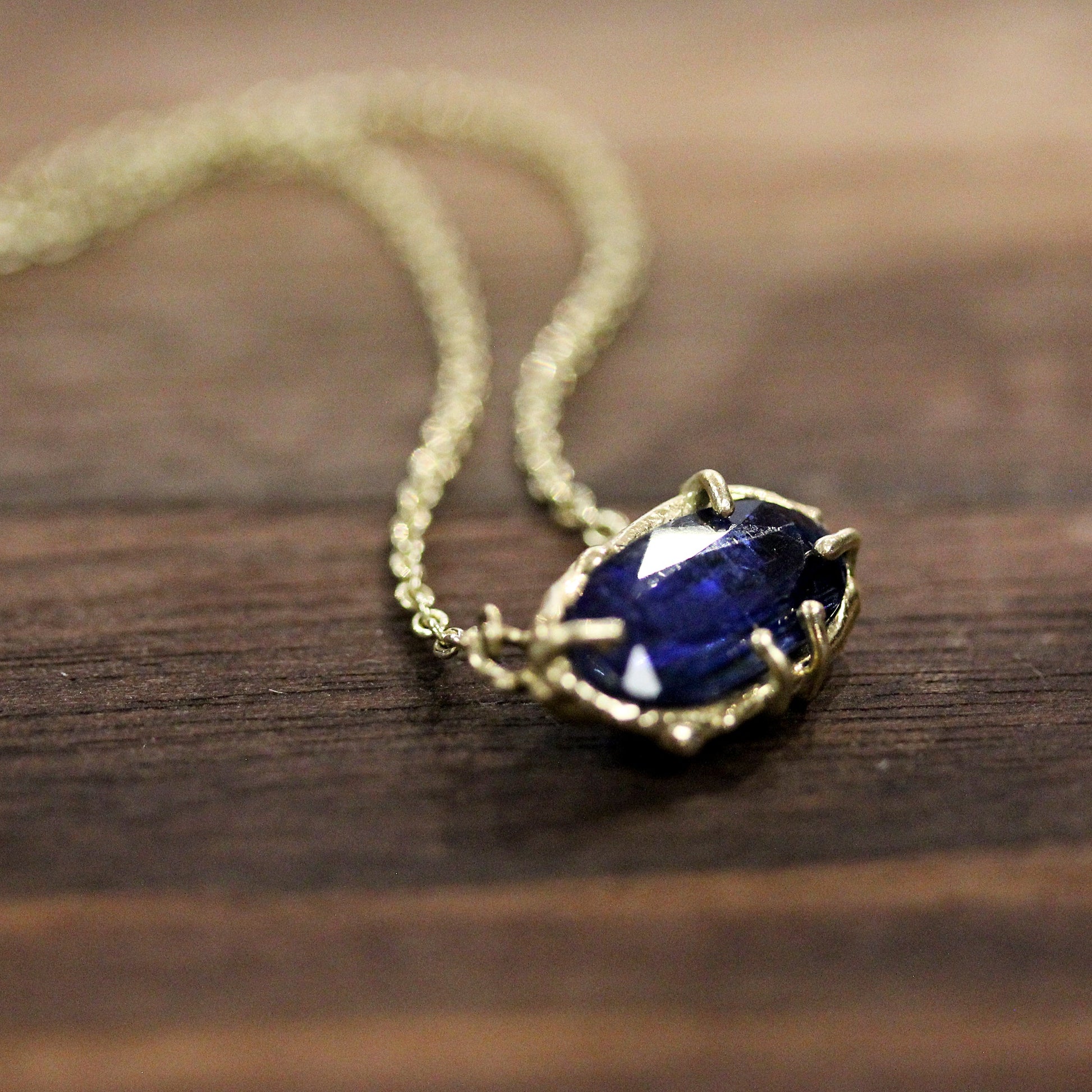 Detail shot of blue kyanite gemstone on Lark Necklace.