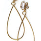 Long, gold statement earrings with a cluster of white topaz gemstone in various shapes at the top and a tear drop shaped dangle.