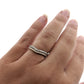 Full view of Karinna Arched MicroPave Band on woman's hand to help give an idea of its scale.