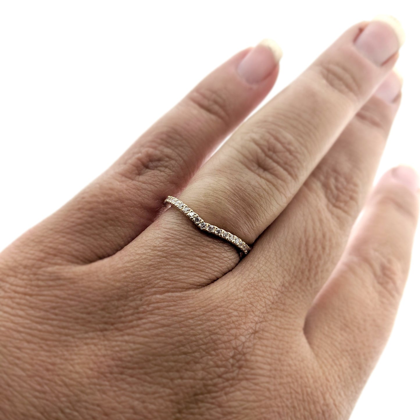 Full view of Karinna Arched MicroPave Band on woman's hand.