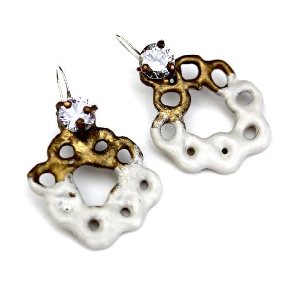 Full view of Kate Earrings. There are a variety of these earrings in different colors but this one is gold and white powdercoated. They are in the shape of a wreath and have a set diamond at the top.