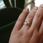 one of a kind moissanite and diamond engagement set on hand