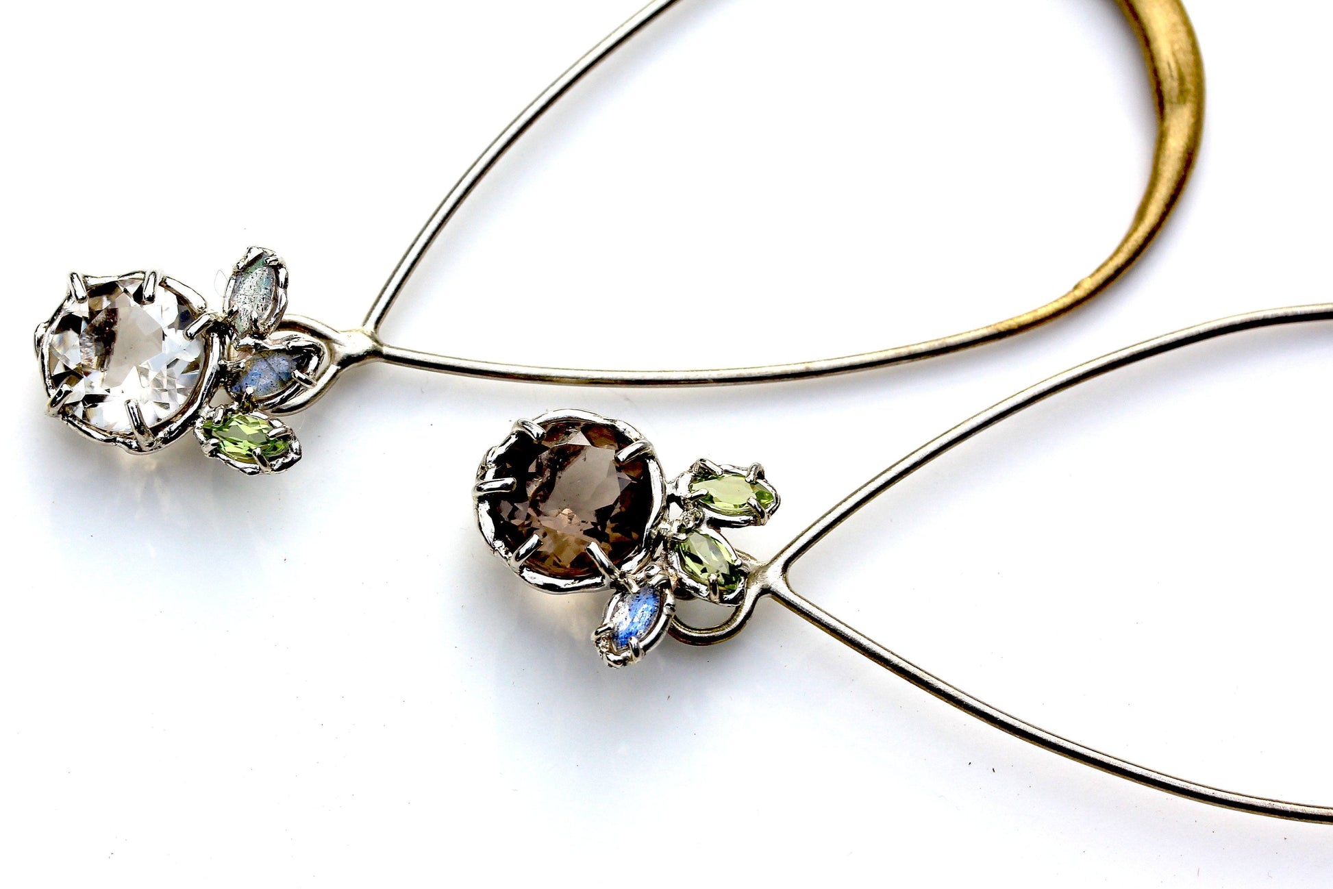 A subtly mismatched pair of earrings in Smoky Quartz, Peridot, Labradorite and Sterling Silver with a Gold Powdercoat accent.