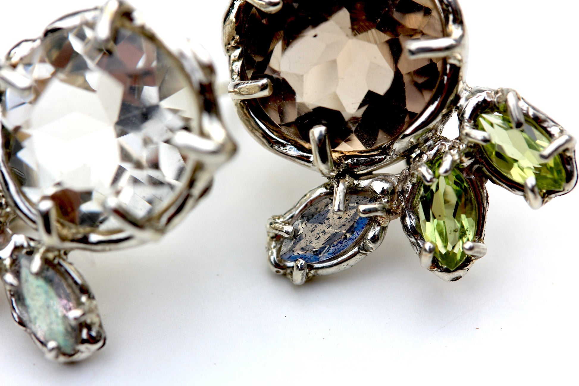 Detail photos of A subtly mismatched pair of earrings in Smoky Quartz, Peridot, Labradorite and Sterling Silver.