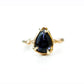 Full view of Lyla Ring. This beautiful purple stone, royal purple lolite, is set in a one of a kind organic hand wrought setting.  Her beautiful shape and vibrant color are a perfect match.  Set in 14K Yellow gold to complement her outstanding, almost glowing color.  