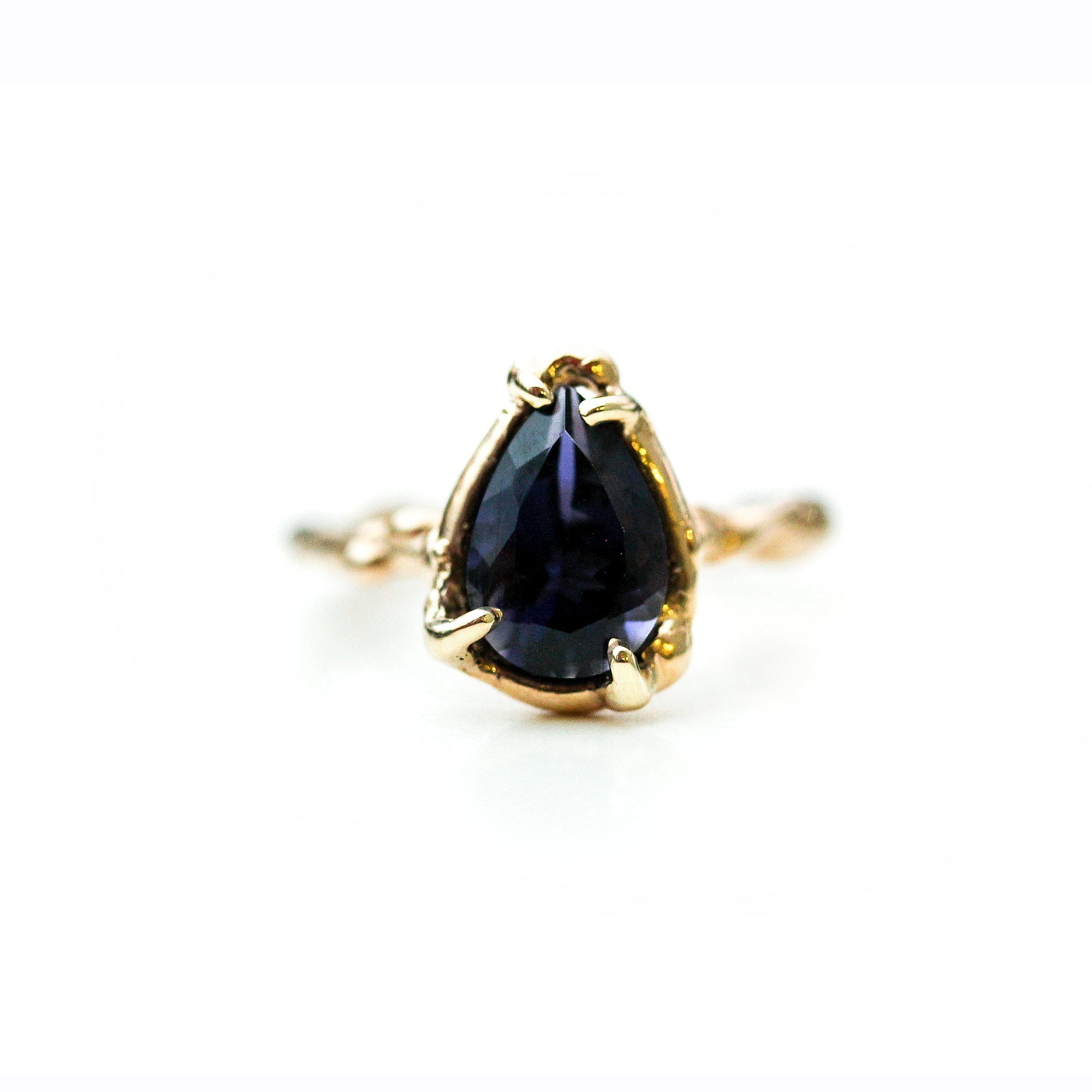 Full view of Lyla Ring. This beautiful purple stone, royal purple lolite, is set in a one of a kind organic hand wrought setting.  Her beautiful shape and vibrant color are a perfect match.  Set in 14K Yellow gold to complement her outstanding, almost glowing color.  
