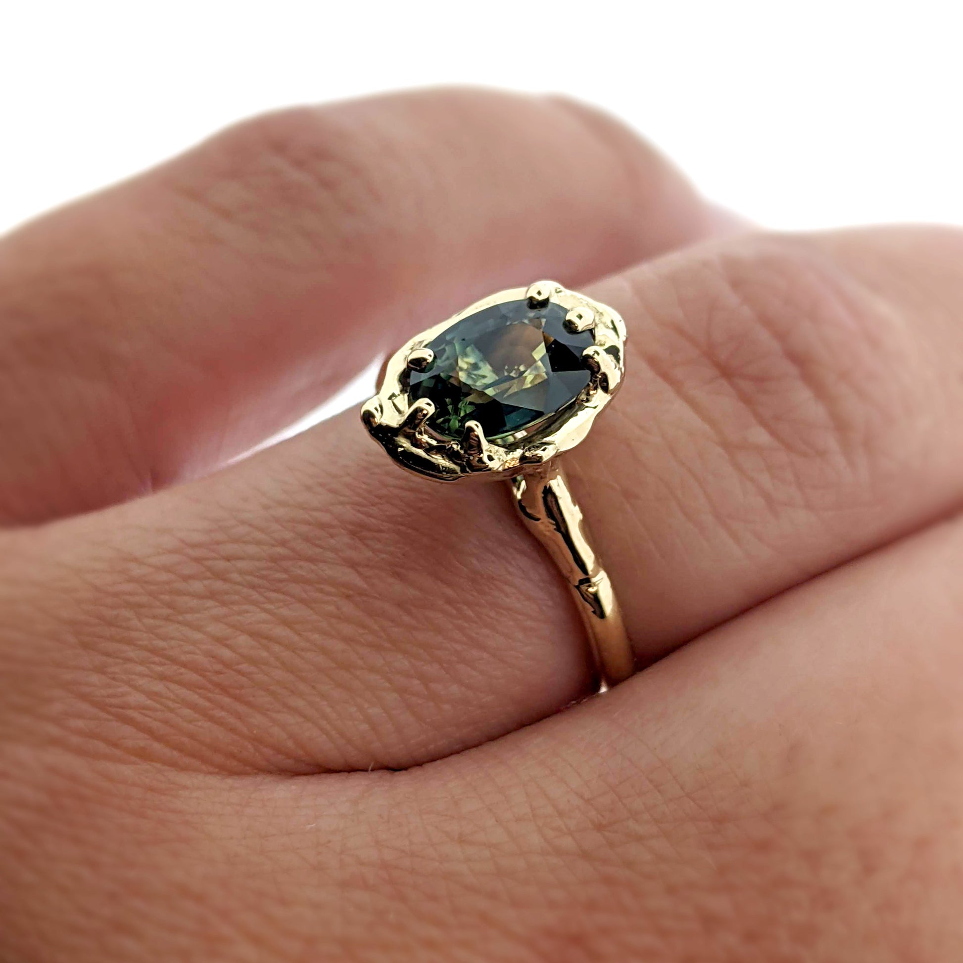 Side view of Rianna Ring on woman's finger to help give an idea of its scale.