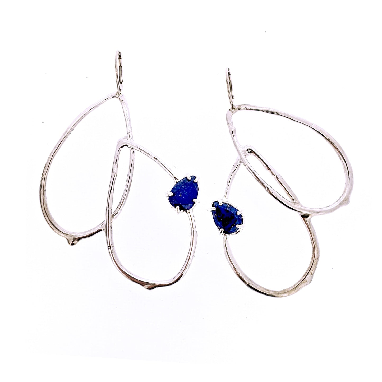 Full view of Harlow Earring - Lapis. An statement earring featuring curved tear-drop shaped forms with an organic texture resembling a smooth twig or vine with a set pear shaped lapis on each earring.