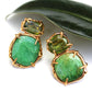 Organic prong set emerald and peridot stud earrings in vermeil.